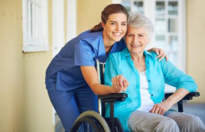 nurse demonstrating the art of caring with senior in wheelchair