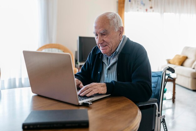 Senior accessing telemedicine on laptop